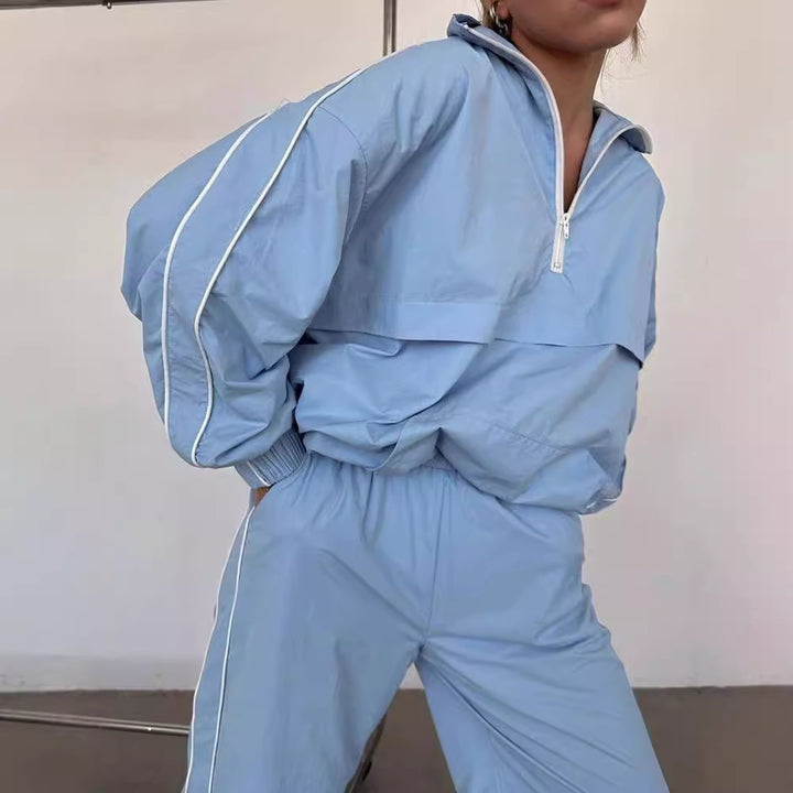 Damen winddichter Crop-Halfzip-Trainingsanzug mit elastischem Bund und kontrastierender Paspel – Avérine
