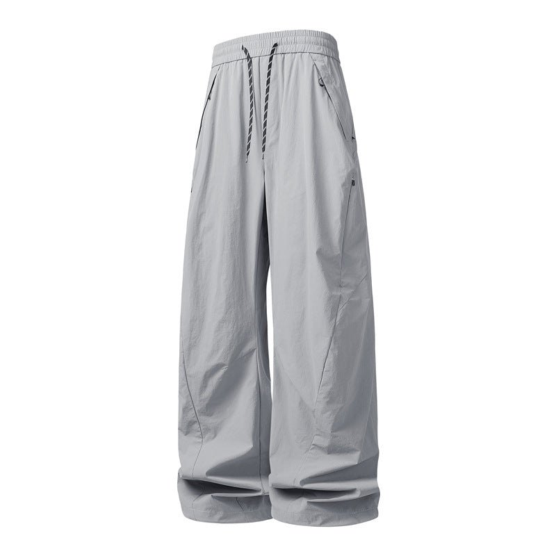 Unisex Weite Tech-Baggy-Hose mit elastischem Kordbund, Reißverschlusstaschen & wasserabweisender Nylonoptik Echoarchiv