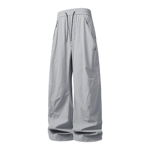 Unisex Weite Tech-Baggy-Hose mit elastischem Kordbund, Reißverschlusstaschen & wasserabweisender Nylonoptik Echoarchiv