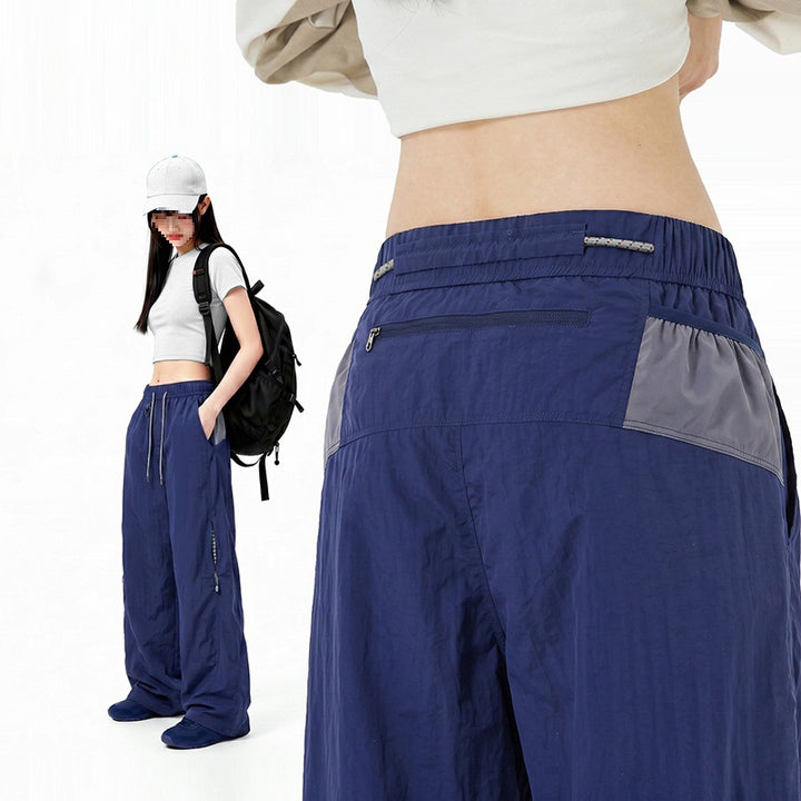 Damen Oversize Tech-Loungehose mit Kontrastnähten, reflektierenden Reißverschlusstaschen & Kordelbund Echoarchiv