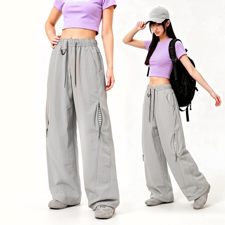 Damen Oversize Tech-Loungehose mit Kontrastnähten, reflektierenden Reißverschlusstaschen & Kordelbund Echoarchiv