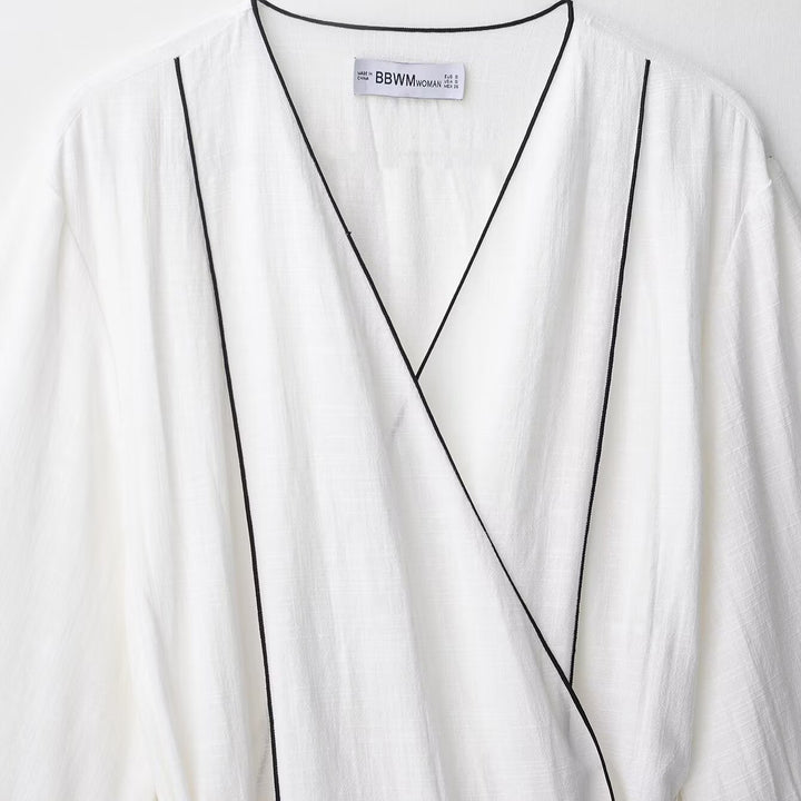 Damen Weite Plisseehose mit hohem Bund, verdeckter Knopfleiste und Kontrastpaspel Echoarchiv