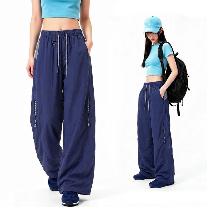 Damen Oversize Tech-Loungehose mit Kontrastnähten, reflektierenden Reißverschlusstaschen & Kordelbund Echoarchiv