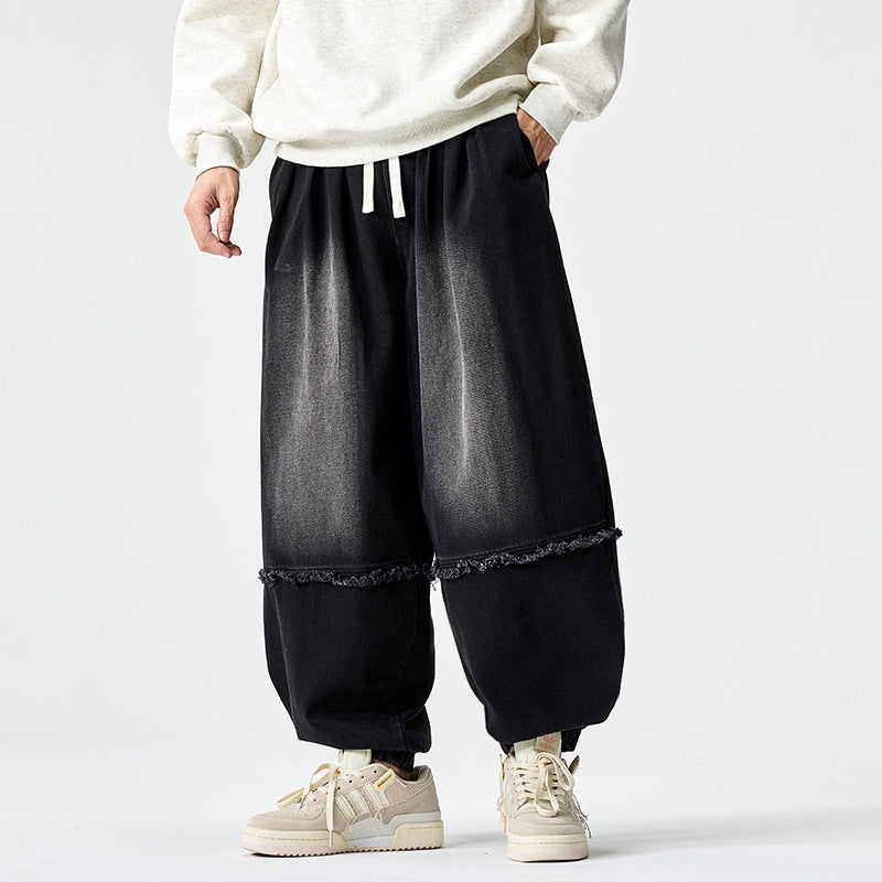 Herren Weit geschnittene Baggy-Denim-Hose mit Tunnelzug, elastischen Beinabschlüssen und Fransen-Detail Echo Archiv
