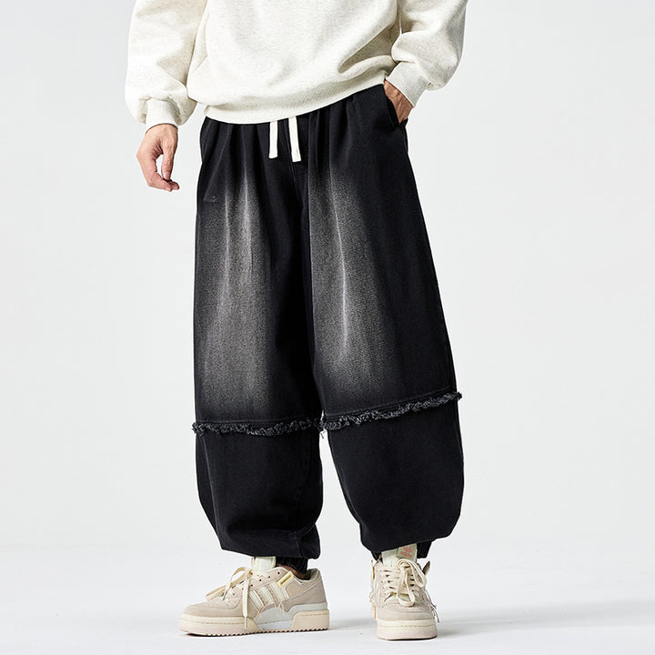 Herren Weit geschnittene Baggy-Denim-Hose mit Tunnelzug, elastischen Beinabschlüssen und Fransen-Detail Echo Archiv