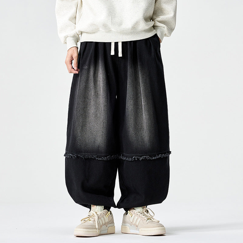 Herren Weit geschnittene Baggy-Denim-Hose mit Tunnelzug, elastischen Beinabschlüssen und Fransen-Detail Echo Archiv