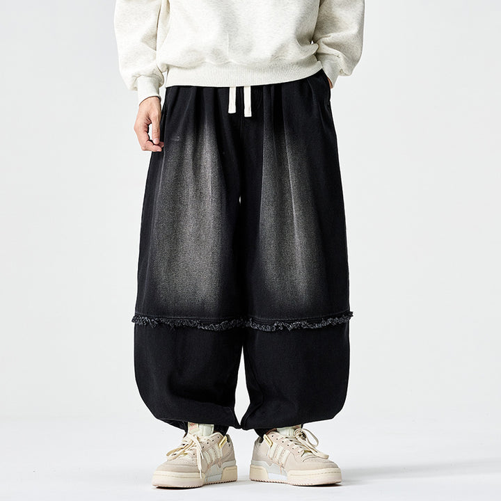 Herren Weit geschnittene Baggy-Denim-Hose mit Tunnelzug, elastischen Beinabschlüssen und Fransen-Detail Echo Archiv