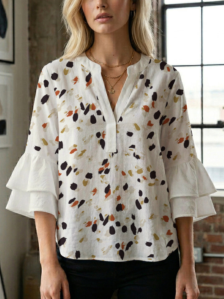 Damen Bluse mit voluminösen Rüschenärmeln und modernem Motiv Echo Archiv