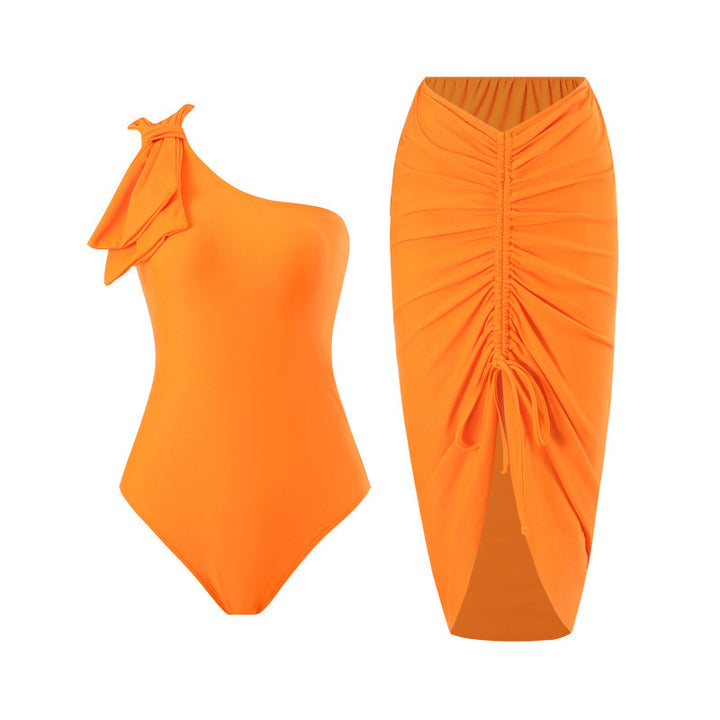 Damen Einteiler Badeanzug mit asymmetrischem Schnitt und modischem Wickelrock Echo Archiv
