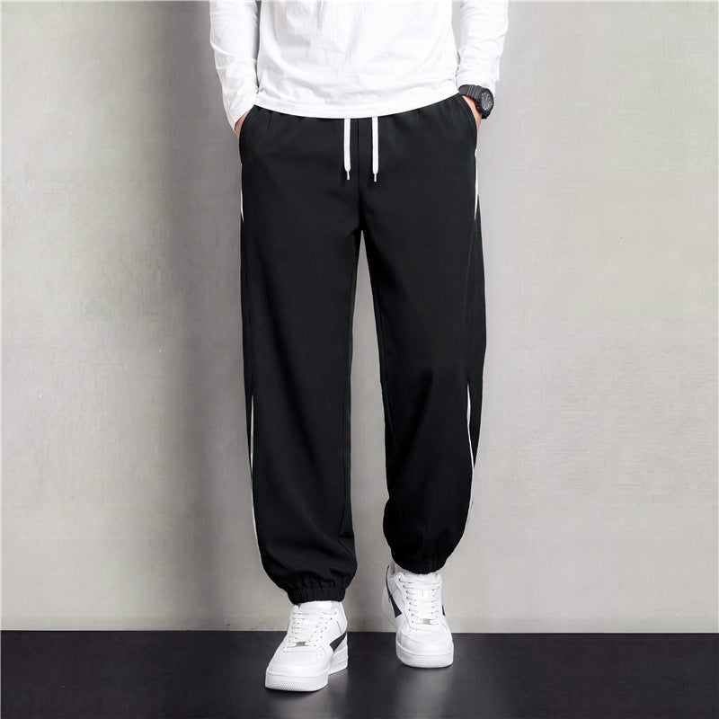 Herren Athleisure Jogginghose im Baggy‑Schnitt mit elastischem Bund, Tunnelzug und seitlichen Kontrastkeilen Echoarchiv