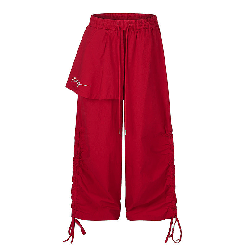 Damen Weite Capri-Hose mit Tunnelzug, seitlicher Raffung und asymmetrischer Überlagerung Echoarchiv