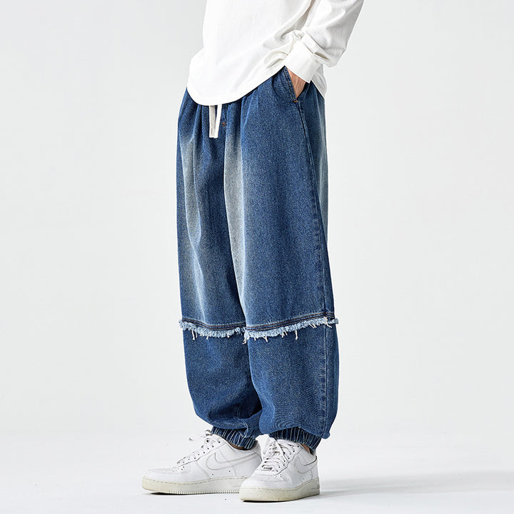 Herren Weit geschnittene Baggy-Denim-Hose mit Tunnelzug, elastischen Beinabschlüssen und Fransen-Detail Echo Archiv