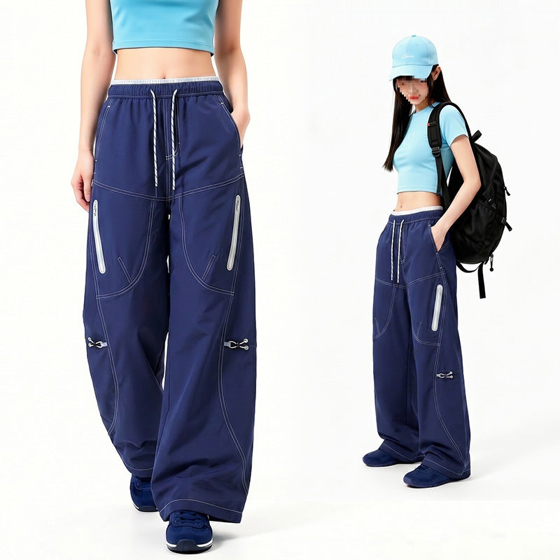 Damen Oversize Tech-Loungehose mit Kontrastnähten, reflektierenden Reißverschlusstaschen & Kordelbund Echoarchiv