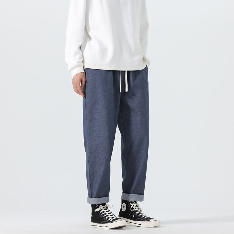 Herren Locker geschnittene Cropped-Denimhose mit Umschlag und Label-Patch Echo Archiv