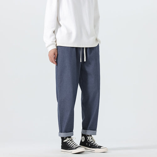 Herren Locker geschnittene Cropped-Denimhose mit Umschlag und Label-Patch Echo Archiv