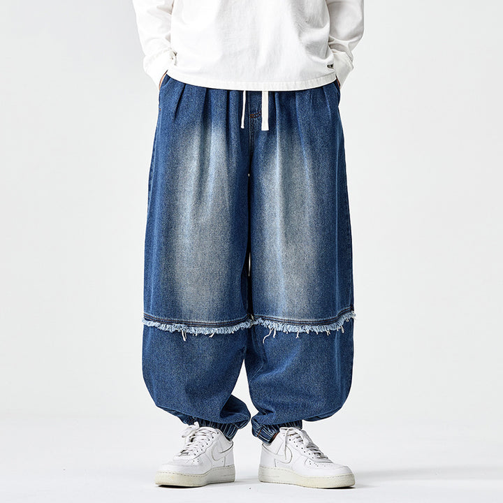 Herren Weit geschnittene Baggy-Denim-Hose mit Tunnelzug, elastischen Beinabschlüssen und Fransen-Detail Echo Archiv