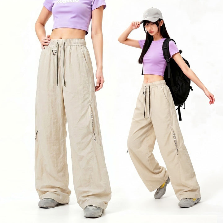 Damen Oversize Tech-Loungehose mit Kontrastnähten, reflektierenden Reißverschlusstaschen & Kordelbund Echoarchiv