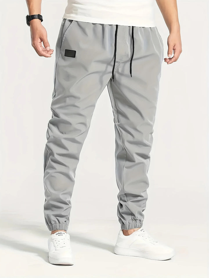Herren Technische Jogginghose im Tapered‑Utility‑Stil mit elastischem Bund & Knöchelbündchen Echo Archiv
