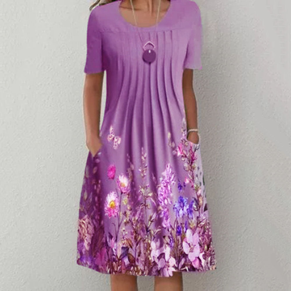Damen Plissee Midi Kleid mit kurzen Ärmeln, seitlichen Taschen und floralem Saum – Élara