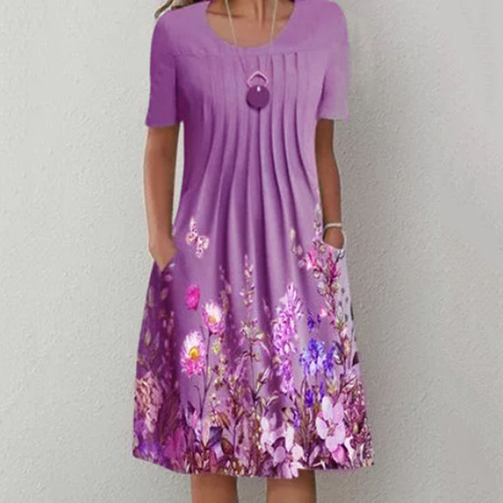 Damen Plissee Midi Kleid mit kurzen Ärmeln, seitlichen Taschen und floralem Saum – Élara
