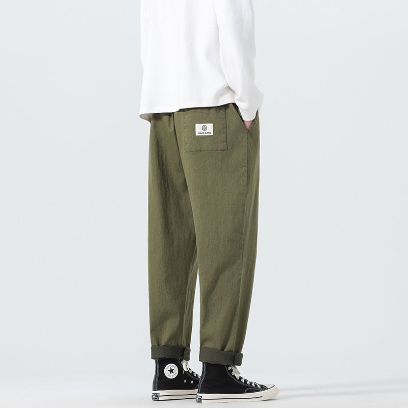 Herren Locker geschnittene Cropped-Denimhose mit Umschlag und Label-Patch Echo Archiv