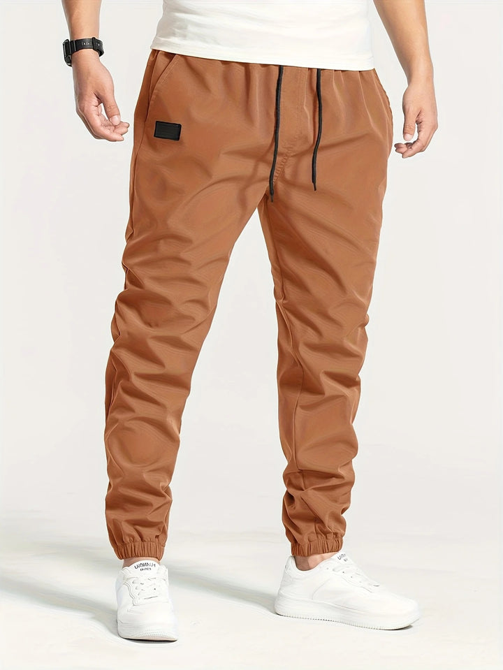 Herren Technische Jogginghose im Tapered‑Utility‑Stil mit elastischem Bund & Knöchelbündchen Echo Archiv