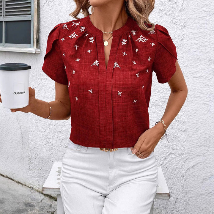 Damen Kurzbluse aus Leinenoptik mit Stehkragen, Zierfalte und floraler Stickerei – Élovi