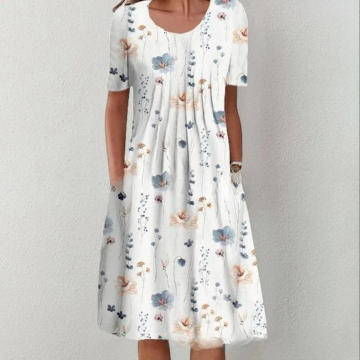 Damen Plissee Midi Kleid mit kurzen Ärmeln, seitlichen Taschen und floralem Saum – Élara