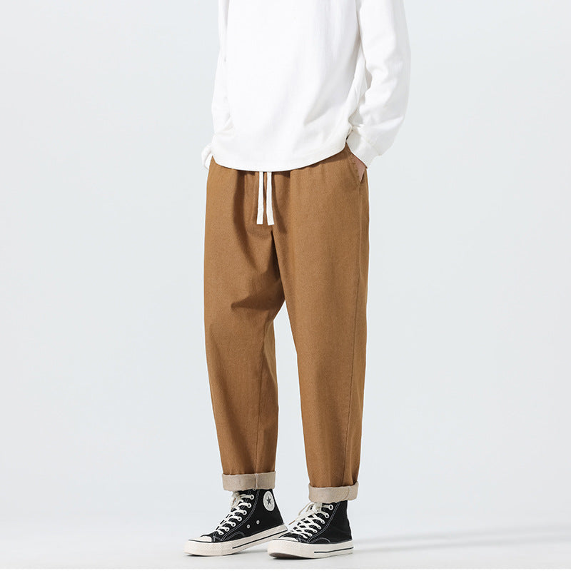 Herren Locker geschnittene Cropped-Denimhose mit Umschlag und Label-Patch Echo Archiv