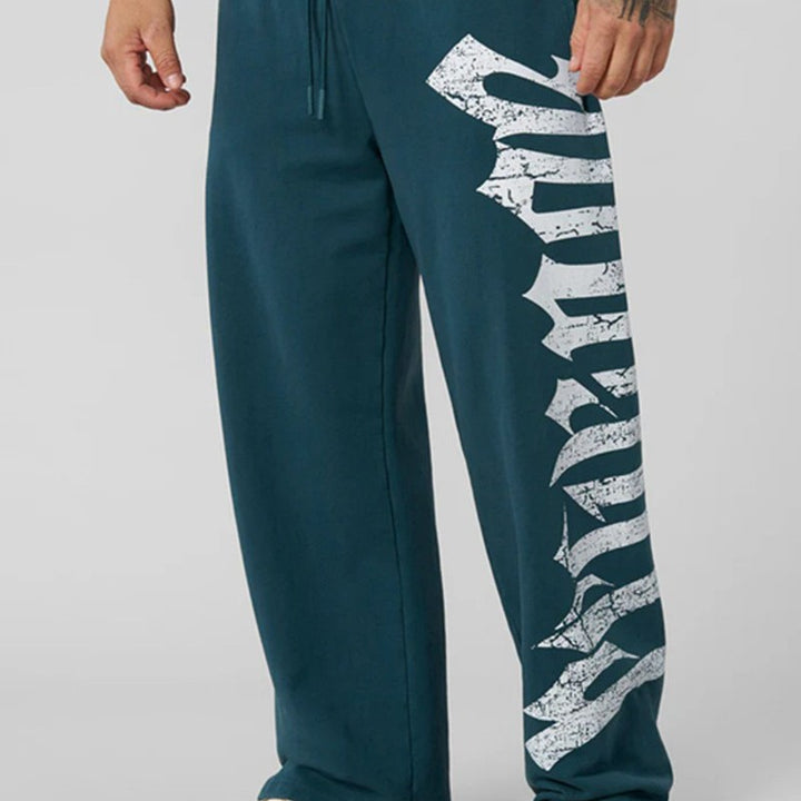Herren nan weite Sweathose aus angerautem Fleece mit seitlichem Vintage-Print und Kordelbund Echo Archiv