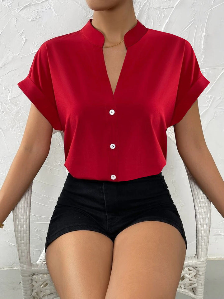 Damen Elegante Kurzarmbluse mit Stehkragen und subtilen Knopfdetails Echoarchiv