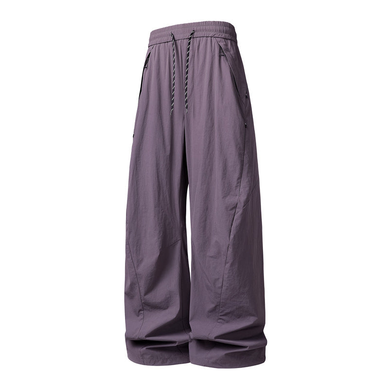 Unisex Weite Tech-Baggy-Hose mit elastischem Kordbund, Reißverschlusstaschen & wasserabweisender Nylonoptik Echoarchiv