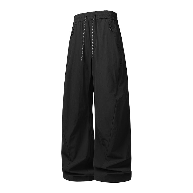 Unisex Weite Tech-Baggy-Hose mit elastischem Kordbund, Reißverschlusstaschen & wasserabweisender Nylonoptik Echoarchiv