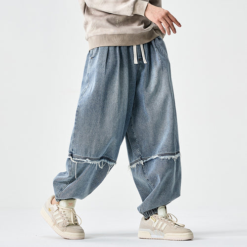 Herren Weit geschnittene Baggy-Denim-Hose mit Tunnelzug, elastischen Beinabschlüssen und Fransen-Detail Echo Archiv