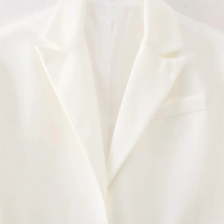 Damen langer Fransen‑Mantelblazer mit Plissee‑Saum, Reverskragen und Pattentaschen – Célinea