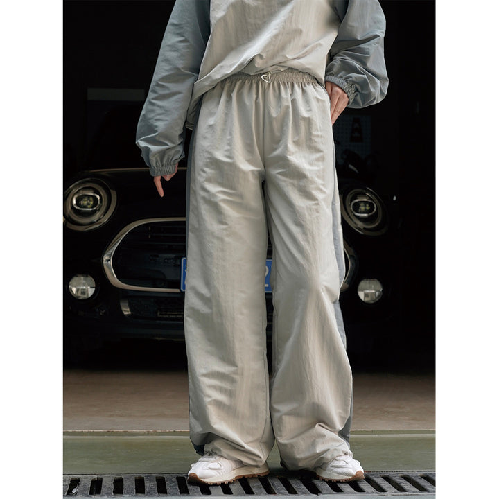 Damen Weite High‑Waist Trackhose im Palazzoschnitt mit kontrastierendem Seitenstreifen Echoarchiv