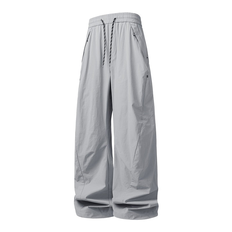 Unisex Weite Tech-Baggy-Hose mit elastischem Kordbund, Reißverschlusstaschen & wasserabweisender Nylonoptik Echoarchiv