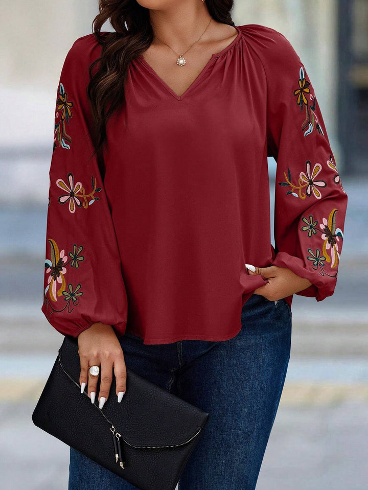 Damen Locker sitzende V-Ausschnitt Bluse mit floraler Stickerei an Ballonärmeln – Élovi
