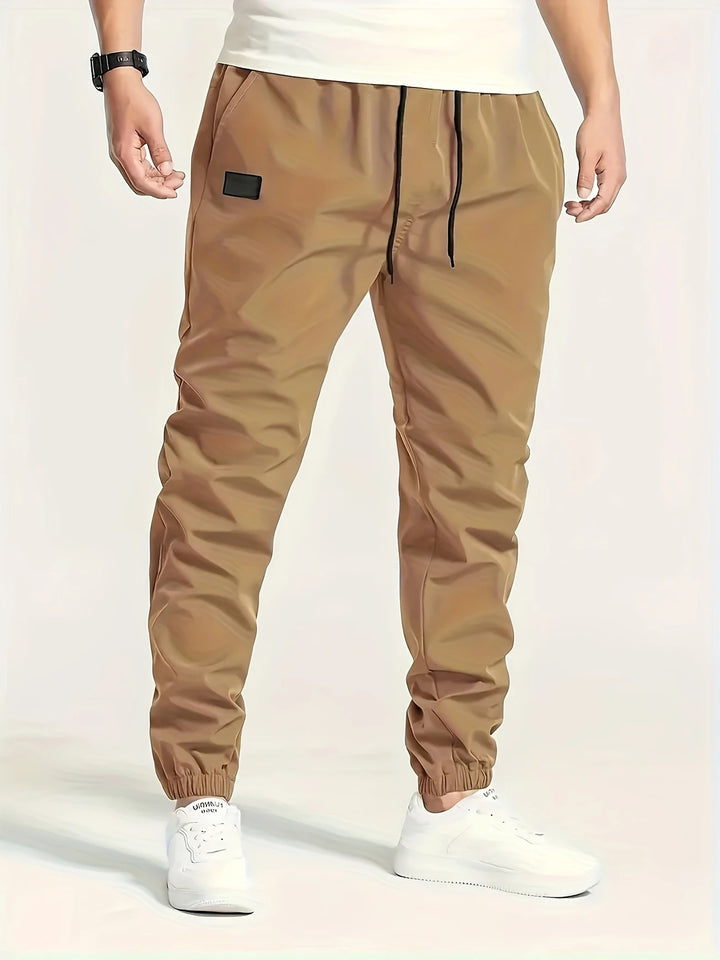 Herren Technische Jogginghose im Tapered‑Utility‑Stil mit elastischem Bund & Knöchelbündchen Echo Archiv