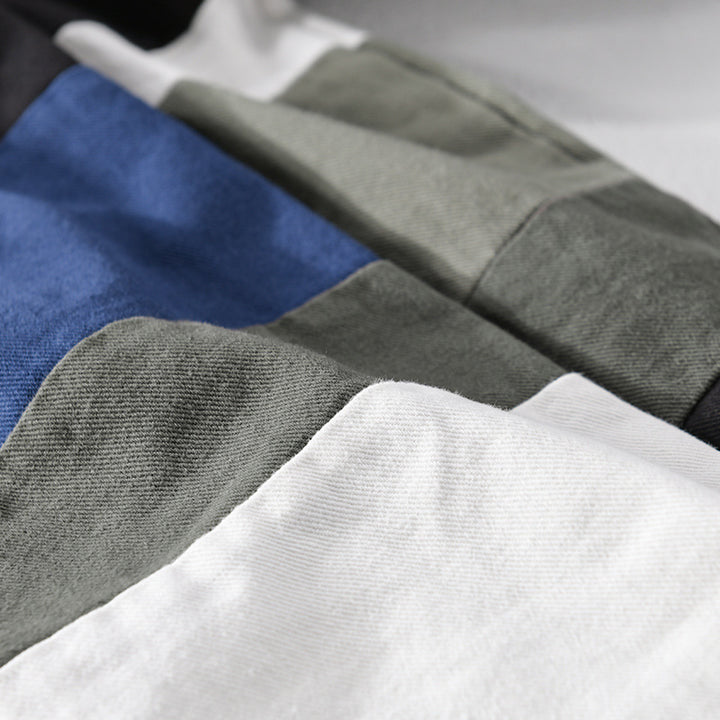 Herren Baumwoll-Overshirt im Layering-Stil mit geometrischen Colorblock-Einsätzen und Druckknopf-Leiste Echoarchiv