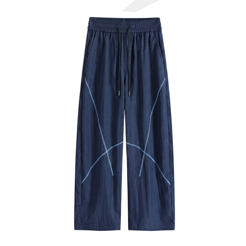 Herren Weite Funktions-Nylonhose mit Kordelbund, reflektierenden Nahtdetails & lässiger Baggy‑Silhouette Echoarchiv