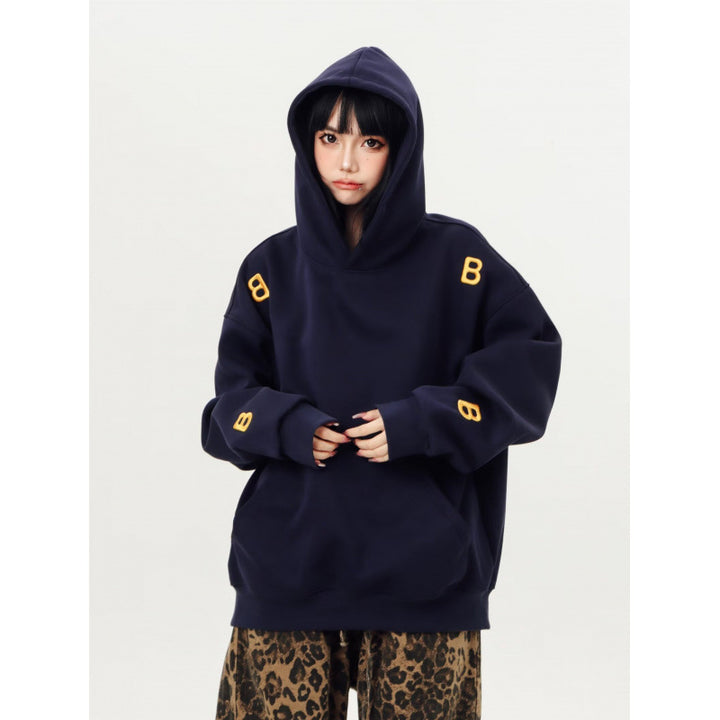 Unisex Oversized Kapuzenpullover mit großflächigem Intarsien‑Blockprint und geripptem Saum Echoarchiv