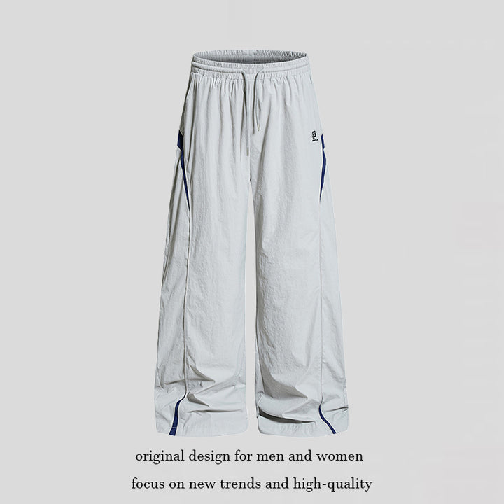 Damen Weite Nylon-Palazzo-Trainingshose mit Tunnelzug, seitlichen Kontrastdreiecken und verstellbarem Saum Echoarchiv
