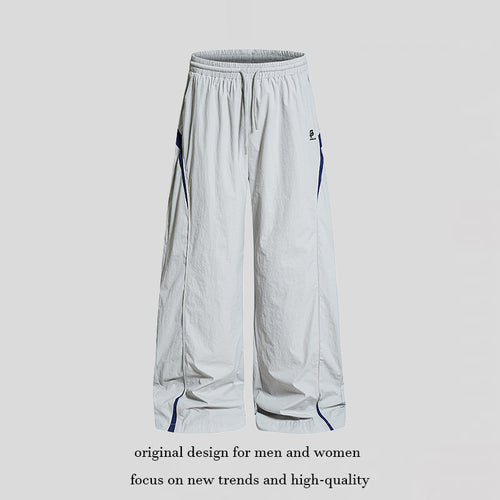 Damen Weite Nylon-Palazzo-Trainingshose mit Tunnelzug, seitlichen Kontrastdreiecken und verstellbarem Saum Echoarchiv