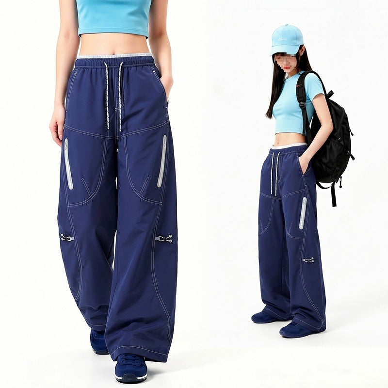Damen Oversize Tech-Loungehose mit Kontrastnähten, reflektierenden Reißverschlusstaschen & Kordelbund Echoarchiv