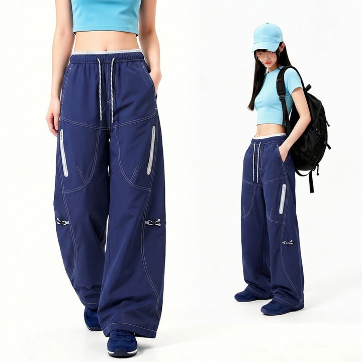 Damen Oversize Tech-Loungehose mit Kontrastnähten, reflektierenden Reißverschlusstaschen & Kordelbund Echoarchiv