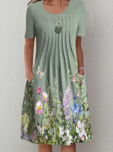 Damen Plissee Midi Kleid mit kurzen Ärmeln, seitlichen Taschen und floralem Saum – Élara