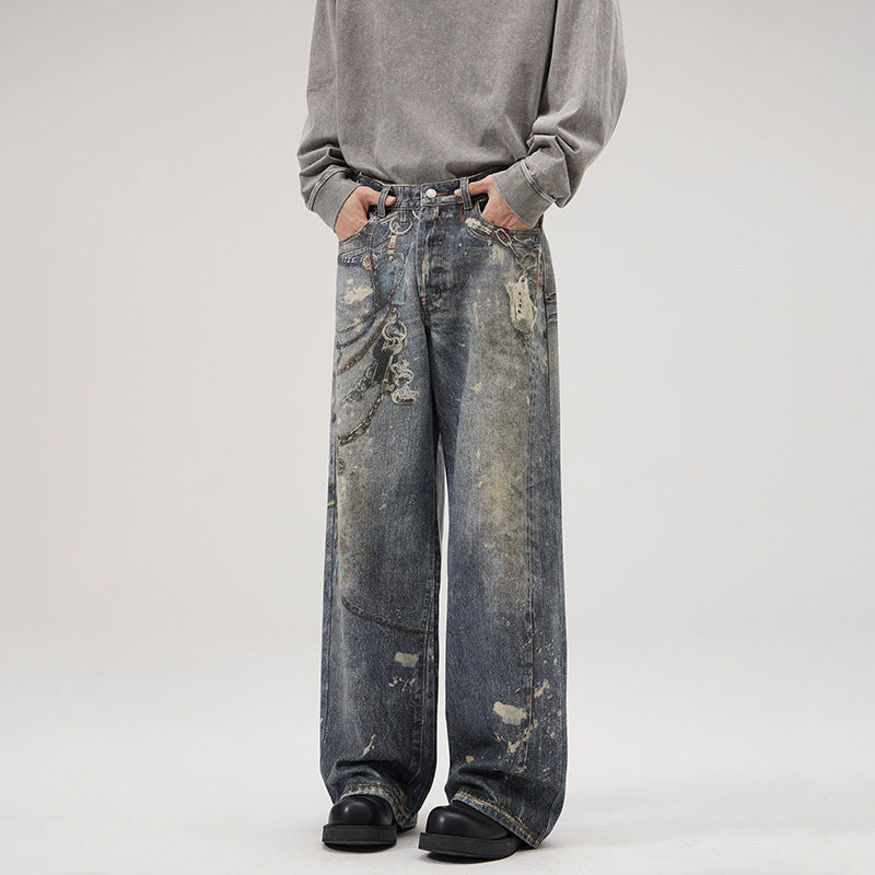 Herren Weit geschnittene Stonewashed-Denim-Jeans mit Kettenprint, Farb‑Splatter und bodenlangem Saum Echo Archiv