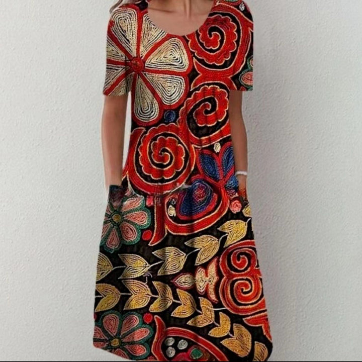 Damen Plissee Midi Kleid mit kurzen Ärmeln, seitlichen Taschen und floralem Saum – Élara