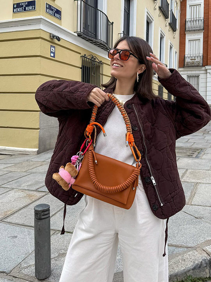 Damen Schultertasche aus Kunstleder mit geflochtenem Henkel und spiralförmigem Vordergriff Echoarchiv